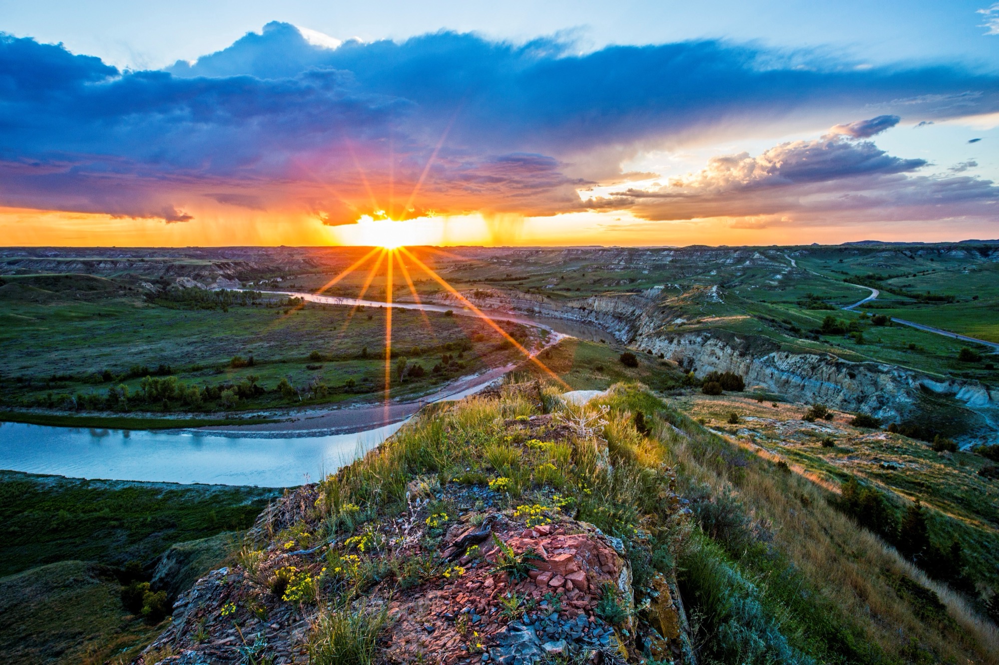 Sunset over the Little Missouri River and layered Badlands at Wind Canyon in Theodore Roosevelt National Park.